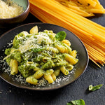 Pasta mit grünem Pesto und geriebenem Käse