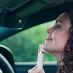 Frau nutzt Velform Epilwiz im Auto zur schnellen Haarentfernung am Kinn.