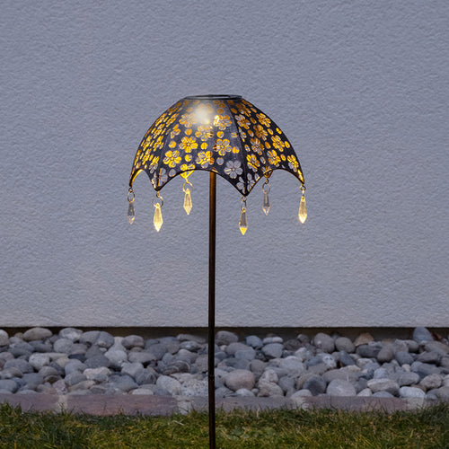 Regenschirm-Gartenleuchte im Rasen, romantisch leuchtend